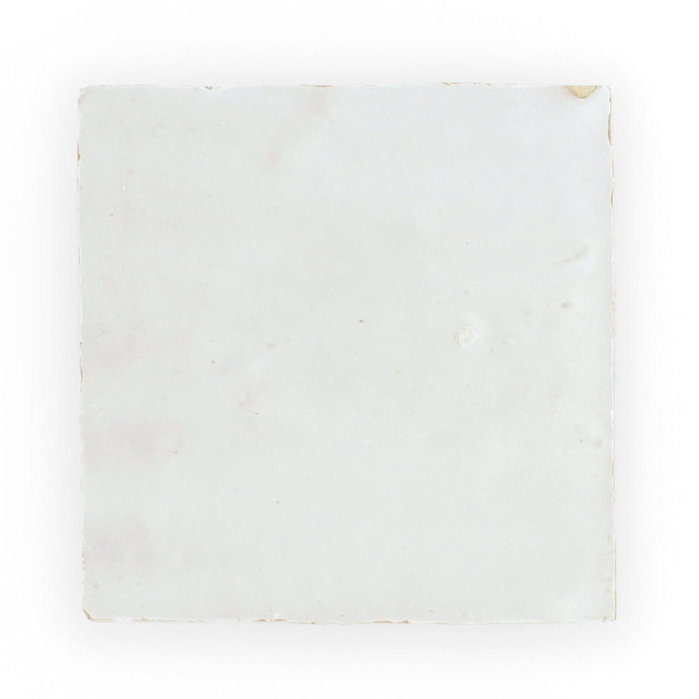 The Ivory Cloud 2X2 sample by New York Cement Tile is a single square white tile with slightly worn edges.