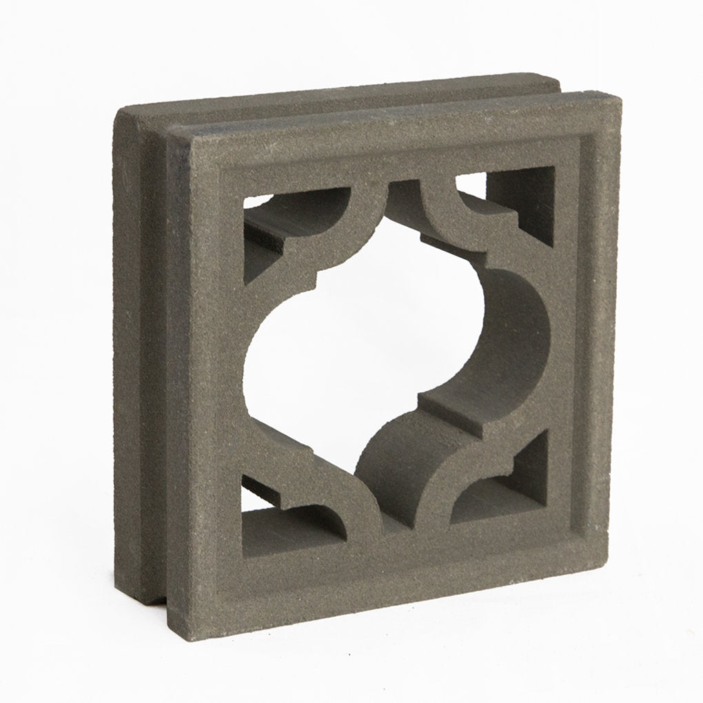 The Myko breeze block by New York Cement Tile features a gray concrete build with a mid-century modern cutout pattern.