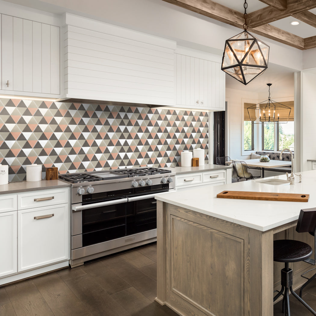 Modern kitchen with white cabinets, a Hex Pie Neapolitan tile backsplash by New York Cement Tile, and wooden island accents.