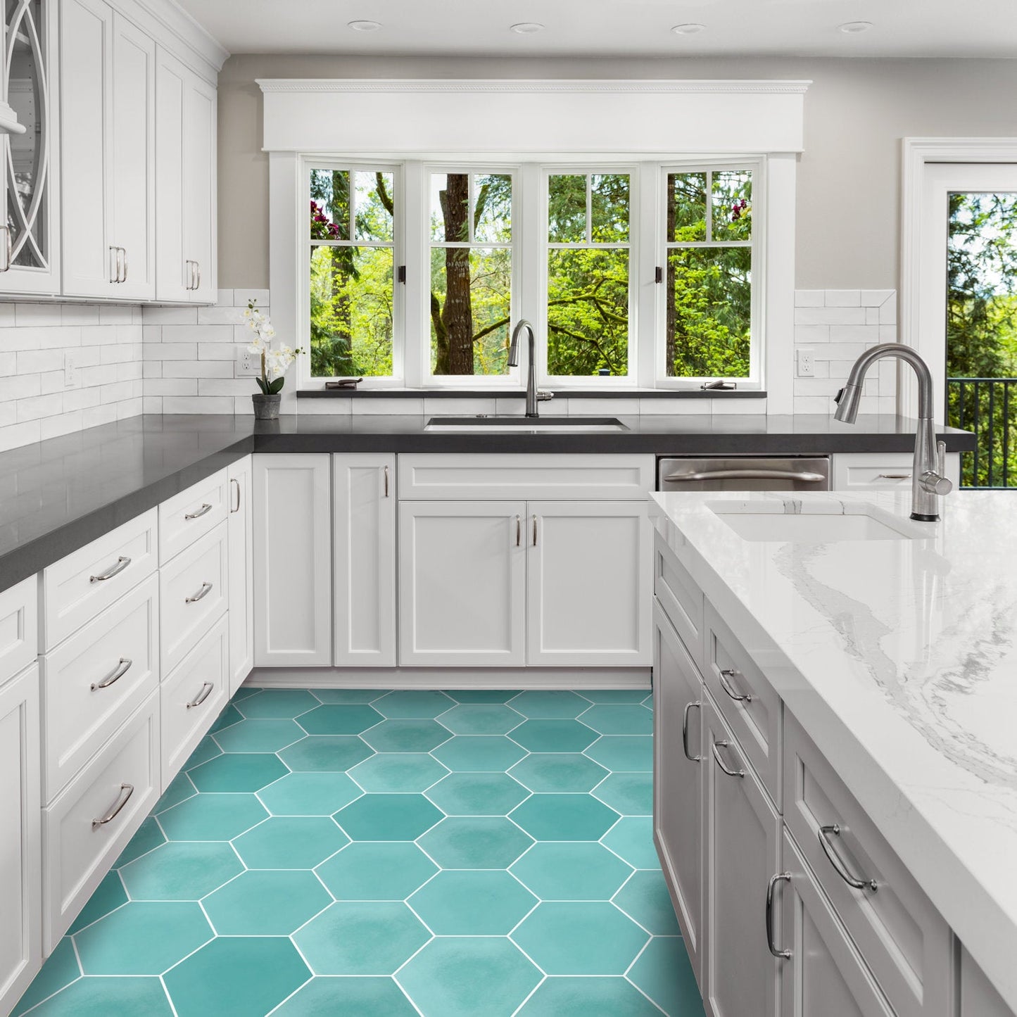 Modern kitchen with NH23-4420 teal hexagon tiles by New York Cement Tile, white cabinets, and black countertops.