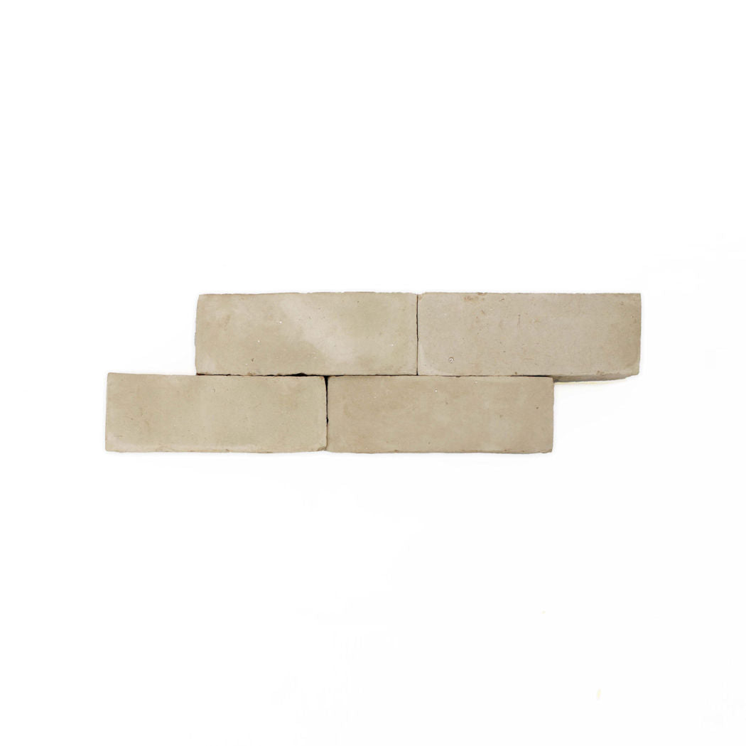 Five Earthy Clay Unglazed (2x6) bricks by New York Cement Tile, in two staggered rows on a white background.