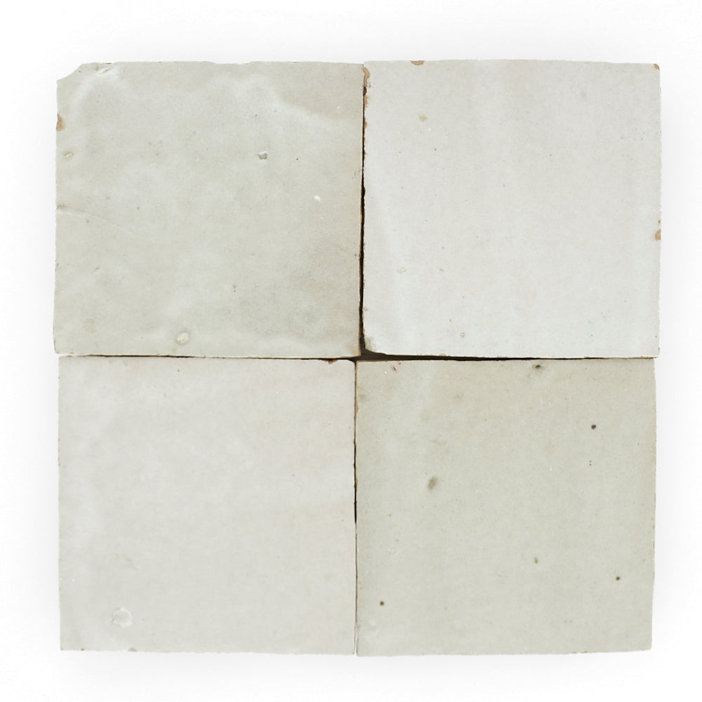 Four Pearl Grey Extra samples by New York Cement Tile, off-white with texture and imperfections, arranged in a 2x2 grid.