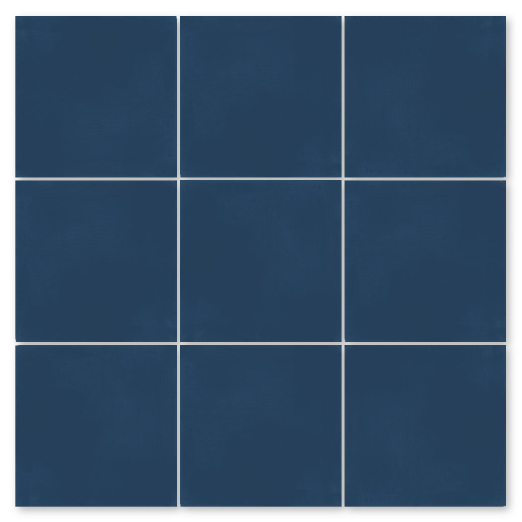 A grid of nine solid dark blue 4x4 tiles by New York Cement Tile with thin white grout lines between them.