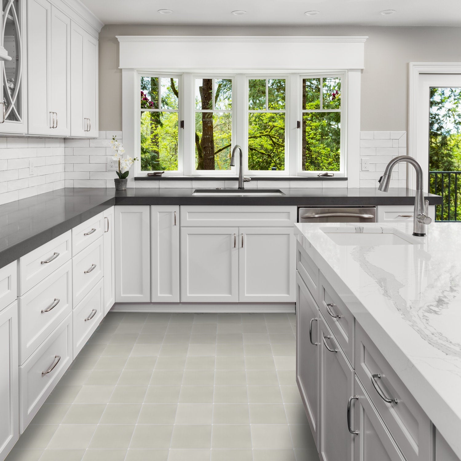 Modern kitchen with New York Cement Tile 2201-Solid gray countertops, white cabinets, large windows, and tree views.