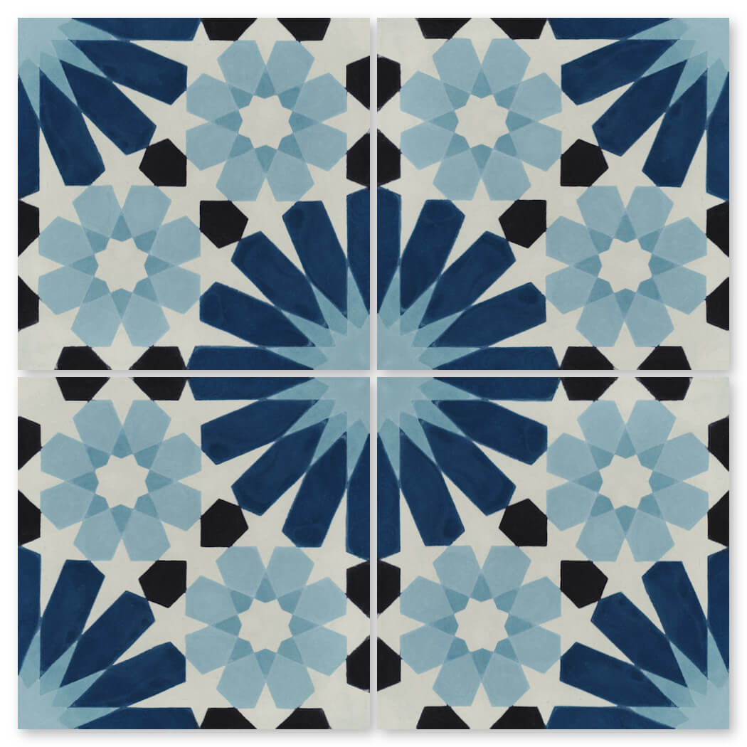 The N20-029 Blue Sample by New York Cement Tile features four blue and black geometric star tiles with handcrafted detail.