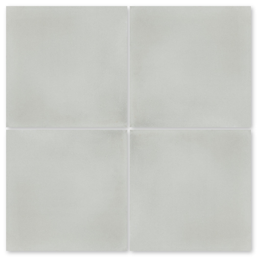 Four 2219-Solid light gray tiles by New York Cement Tile in a 2x2 grid on a white background.