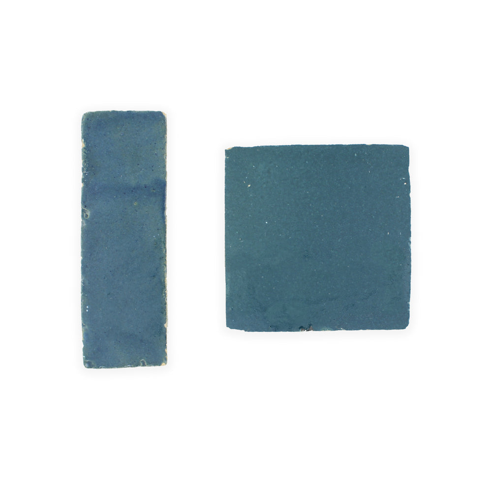 Two blue Sea Breeze (2x6) tiles by New York Cement Tile—one rectangular, one square, on a white background.