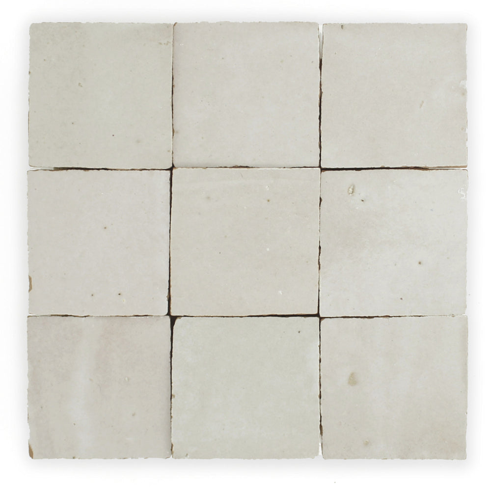 Nine Pearl Grey sample tiles by New York Cement Tile in a 3x3 grid, each with unique off-white texture and color.