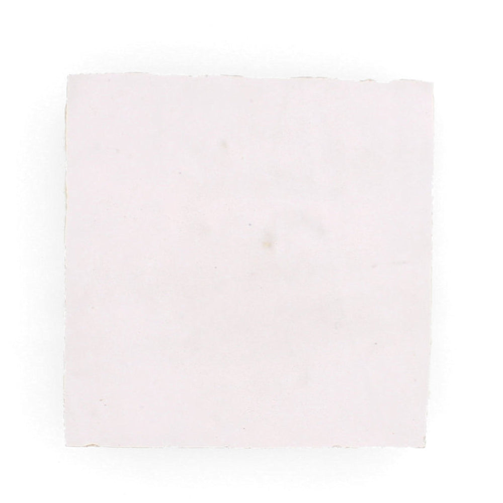 A square Rosy Pink 2x2 sample from New York Cement Tile with rough, handcrafted tile-like edges.