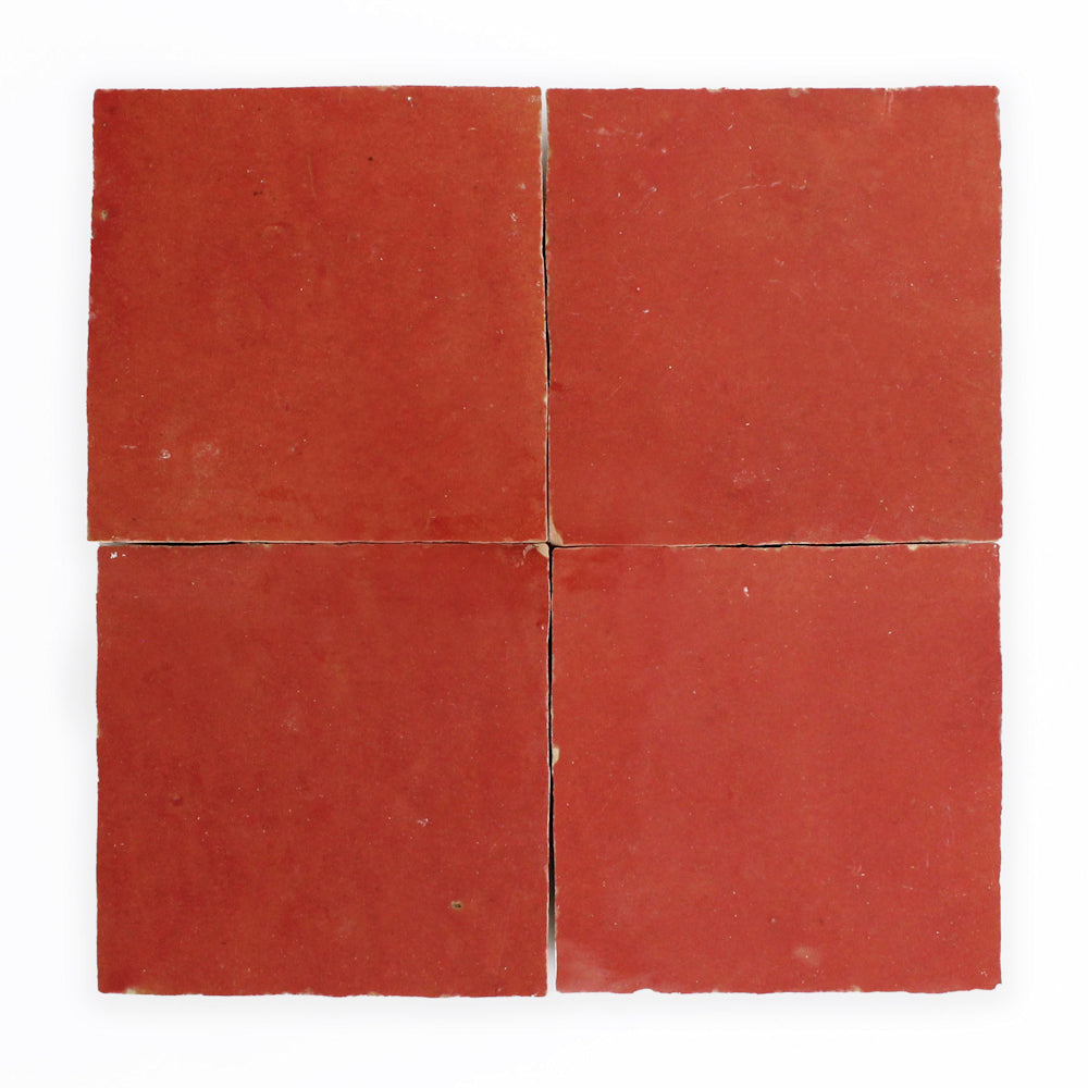 Four Fiery Red 2x2 tiles by New York Cement Tile arranged in a square on a white background.