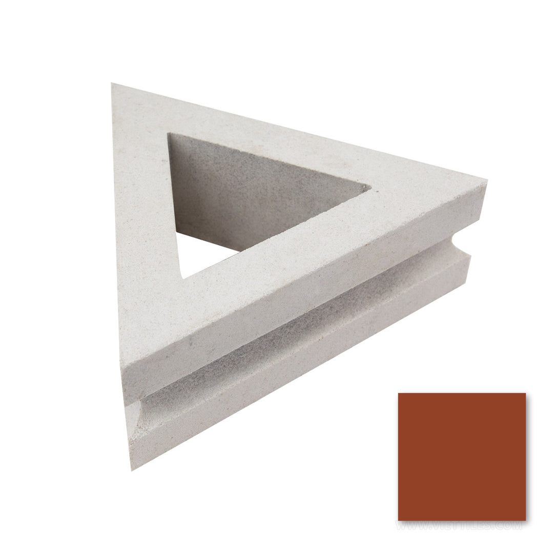 Nui Triangular by New York Cement Tile: white triangular block with hollow center, shown beside a reddish-brown swatch.