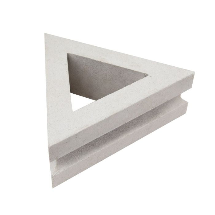 The Nui Triangular by New York Cement Tile is a white, three-sided object with a hollow center inspired by breeze blocks.