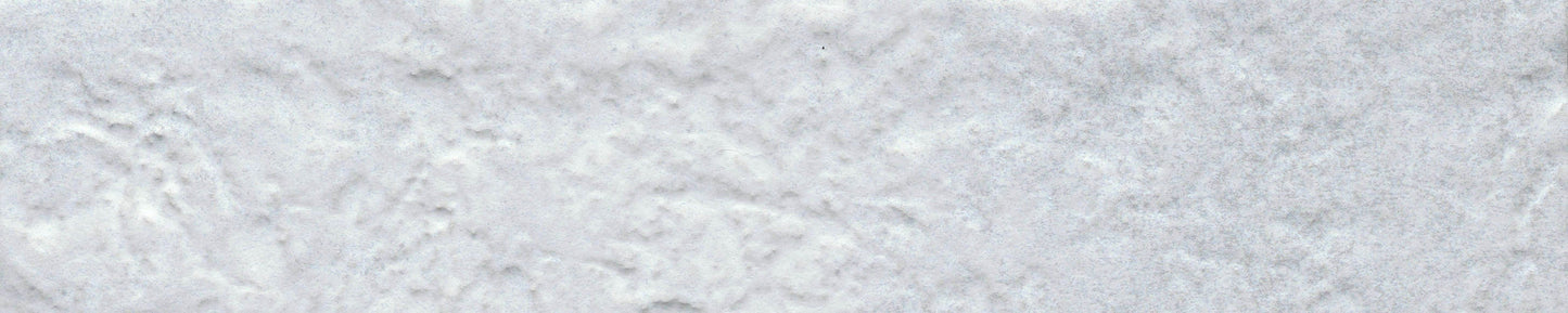 Close-up of New York Cement Tile's Silver - Brique - Sample, a textured white tile with soft shadows and creased details.