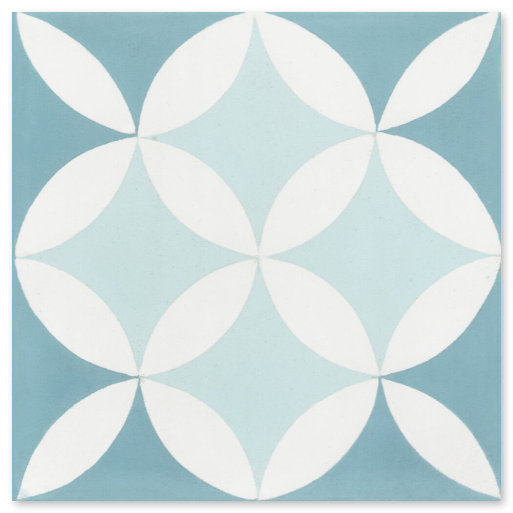 New York Cement Tile’s N20-061/062 features overlapping white leaf shapes on blue tones in a symmetrical geometric pattern.