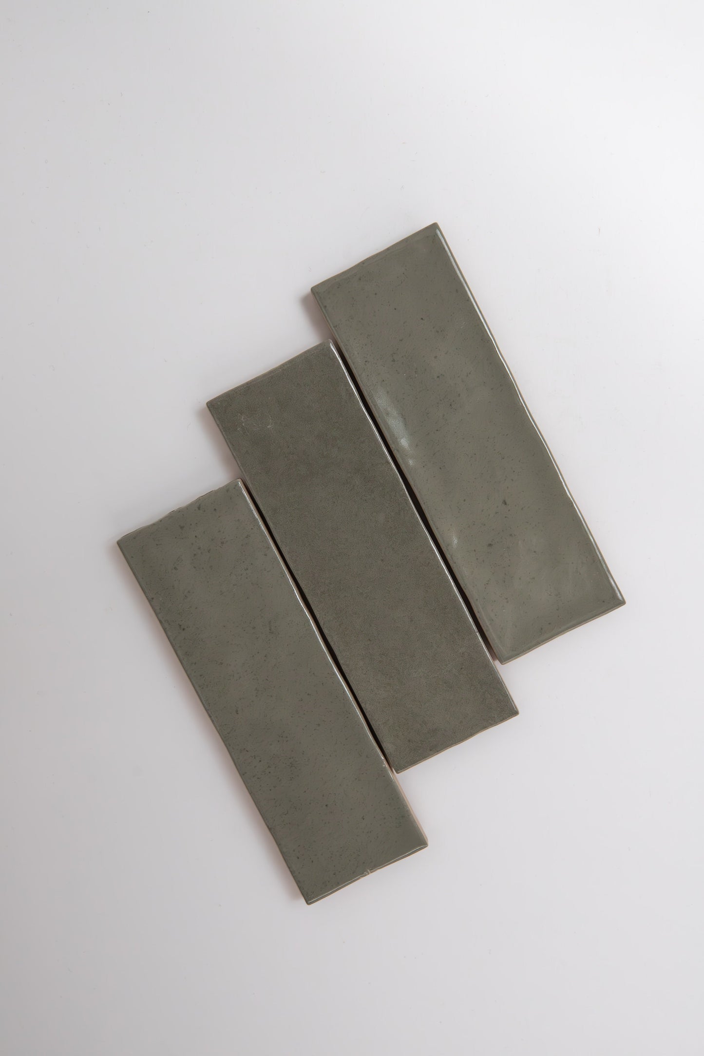 Three rectangular Skye Green ceramic tiles by Cottage Ivy are arranged diagonally on a plain white background.