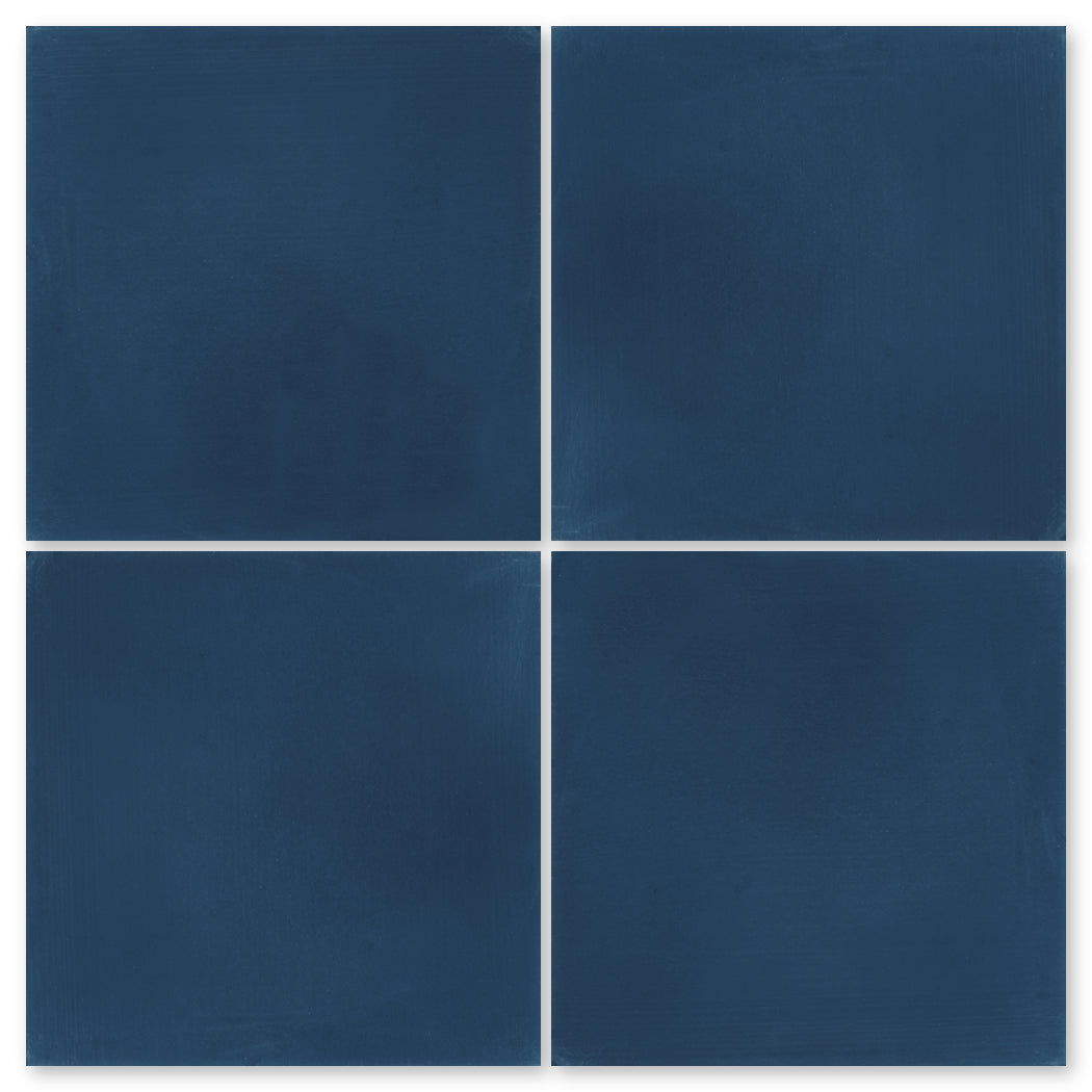 Four 4412-Solid 8x8 tiles by New York Cement Tile, dark blue, handcrafted, arranged 2x2 with slight gaps between.