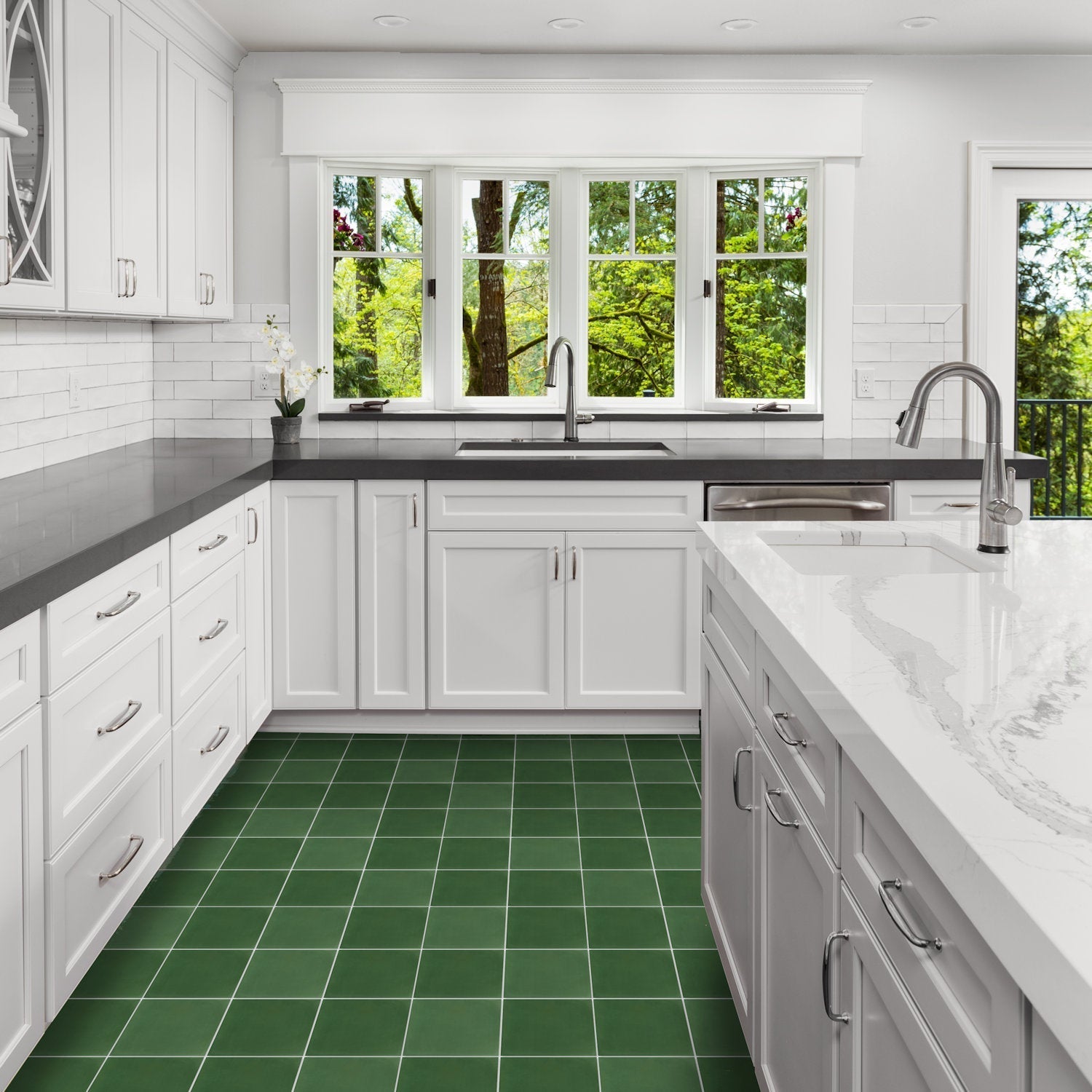 Modern white kitchen with New York Cement Tile 3343-Solid 8x8 green floor, black-white counters, and steel fixtures.