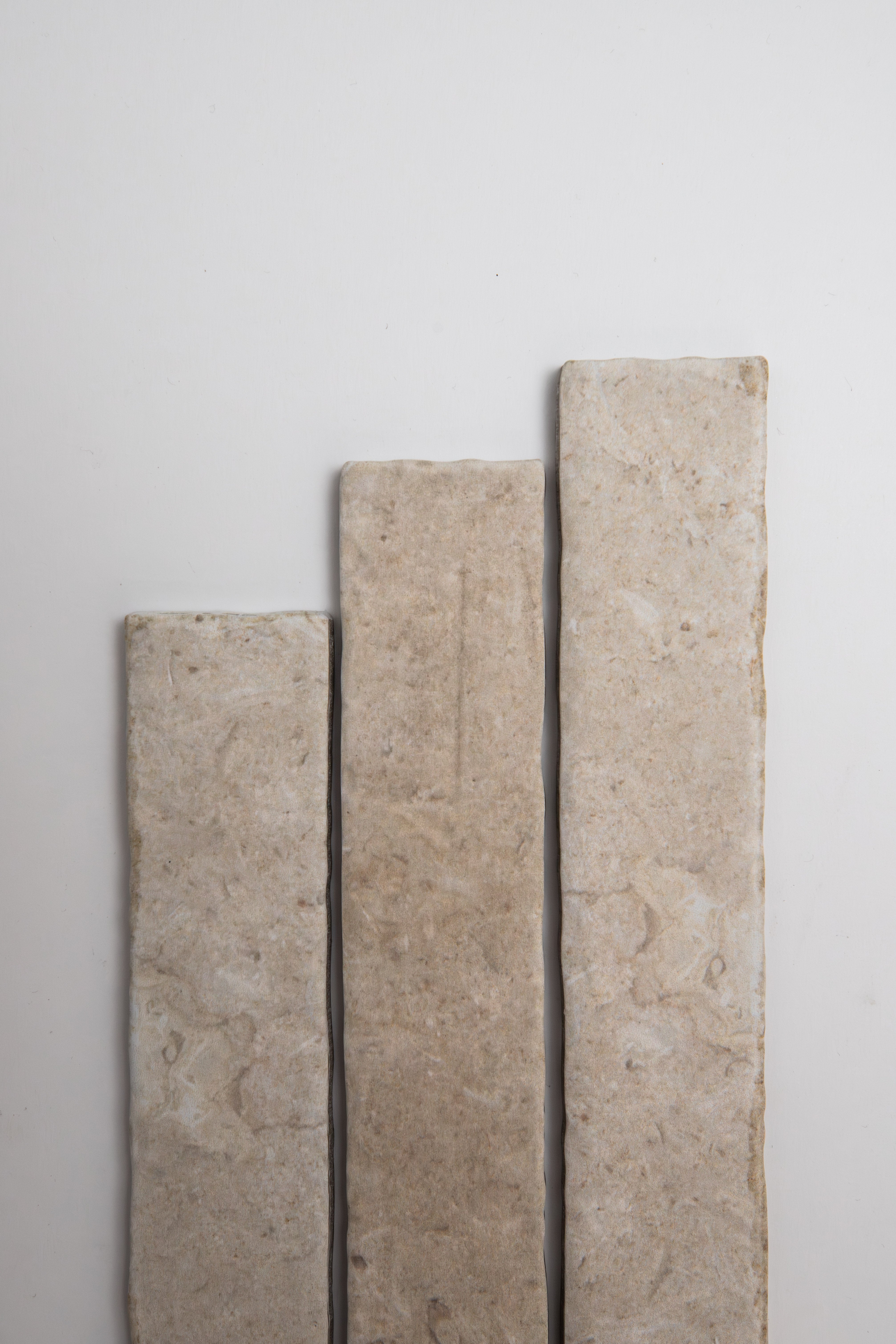 Three Toba Ivory R11 tiles by Toba are arranged vertically in ascending height on a plain white background.