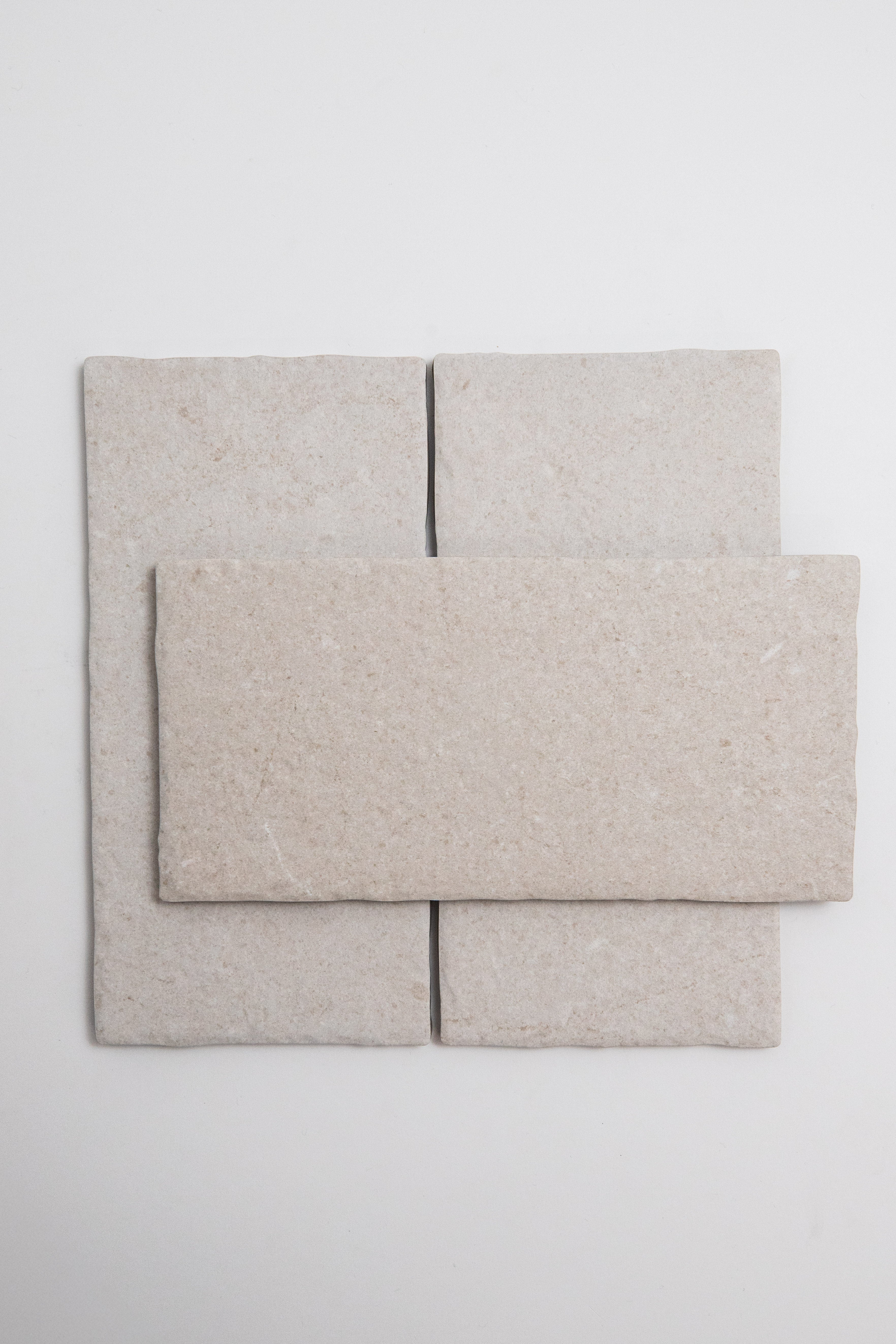 Three Toba Multicolor R11 tiles—two vertical side by side, one horizontal on top—are arranged in light beige.