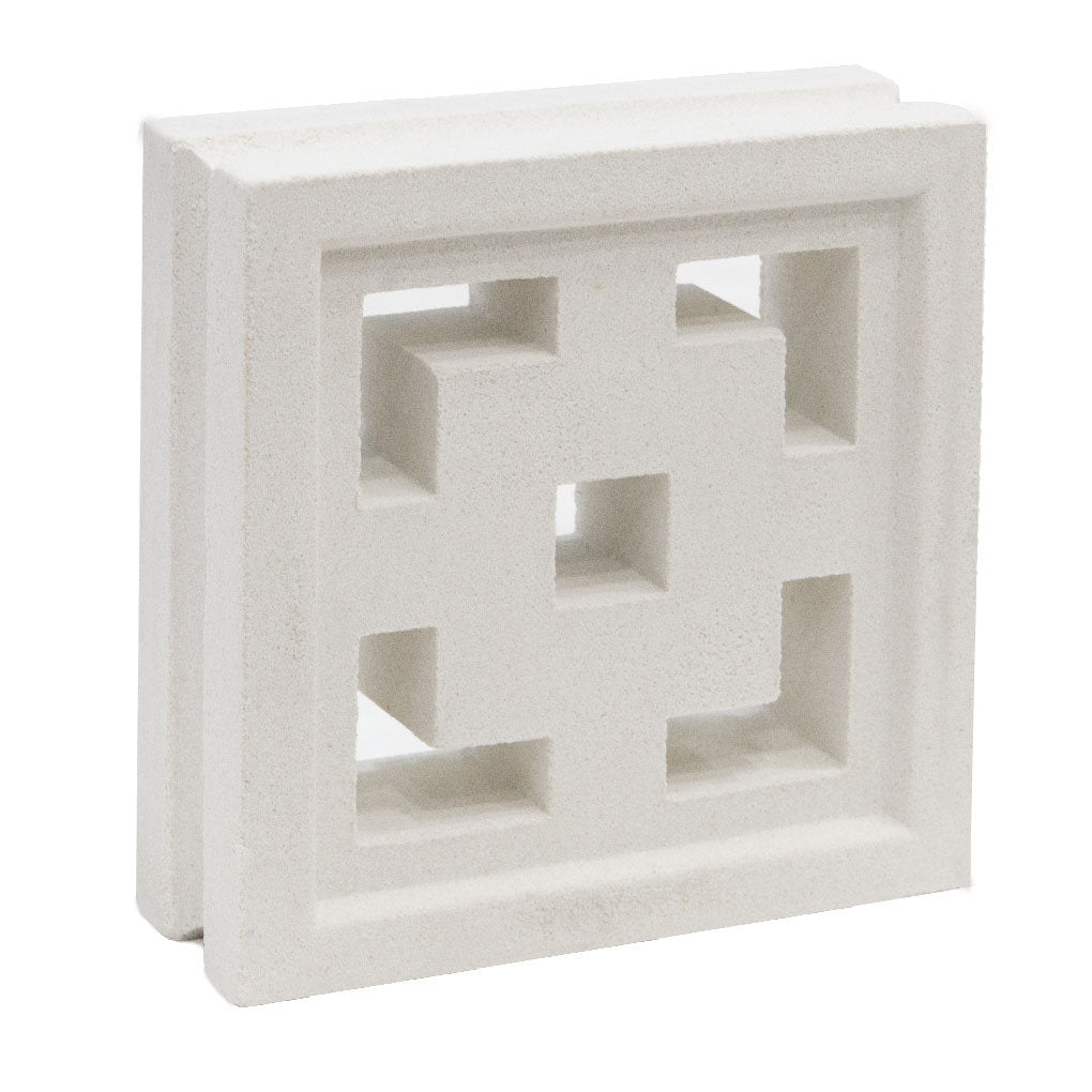 The Tong by New York Cement Tile is a square white breeze block with geometric cut-outs, ideal for stylish partitions.