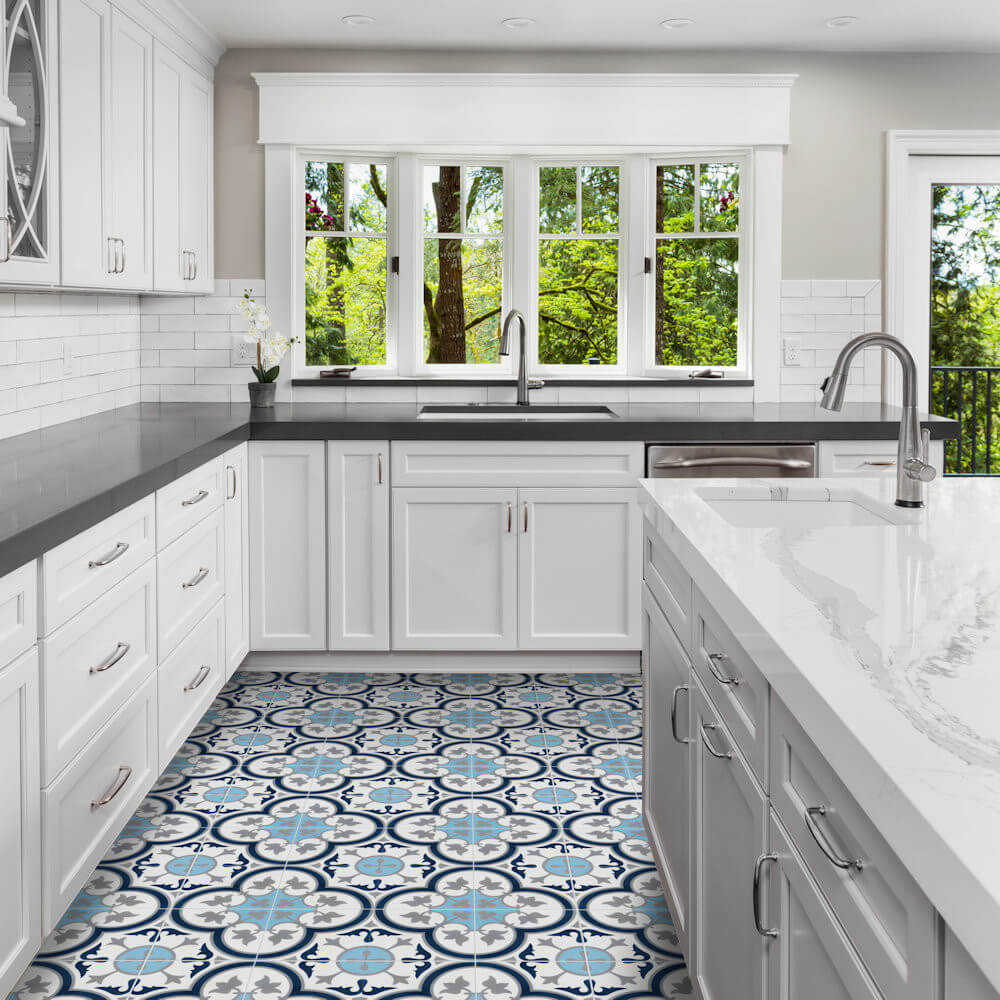 Bright kitchen with white cabinets, gray counters, and N20-045 Ice Blue tiles by New York Cement Tile on the floor.