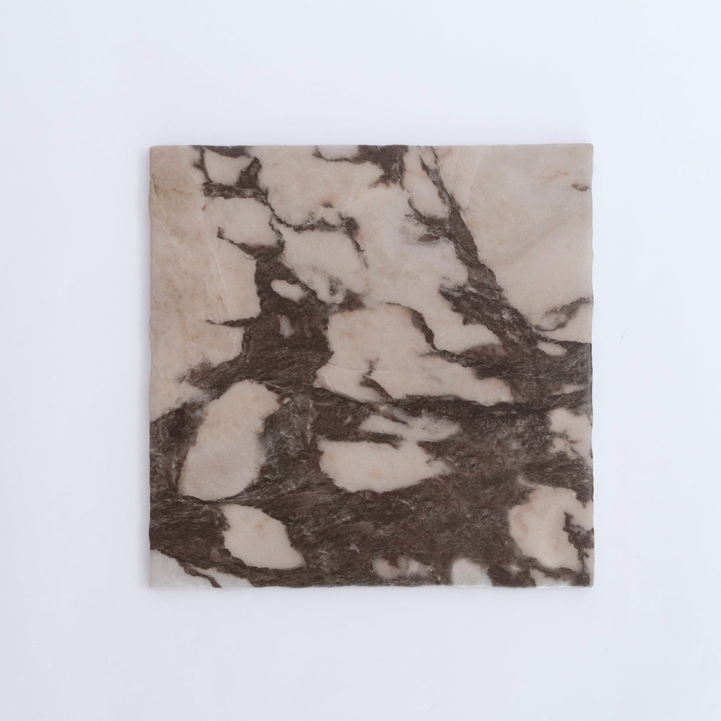 Viola by New York Cement Tile: a square marble tile with cream and dark brown veining on a plain white background.