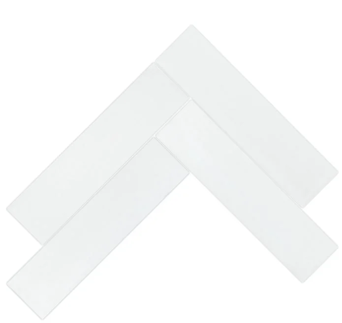 The 2X8 Solid white tiles by New York Cement Tile create a classic herringbone design on a white background.