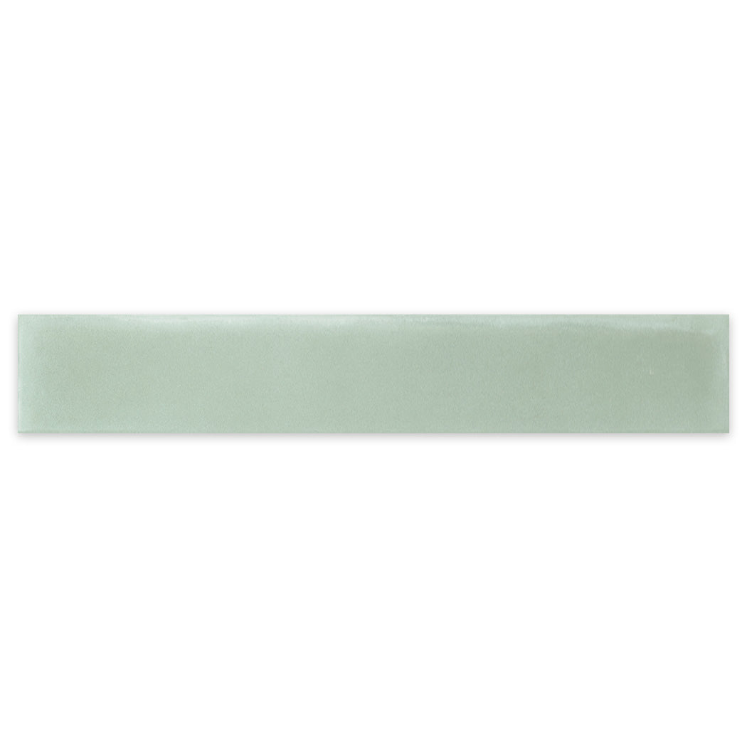 2x12" Solid Pale Jade ceramic tile sample by New York Cement Tile, light green with a glossy finish and clean edges.