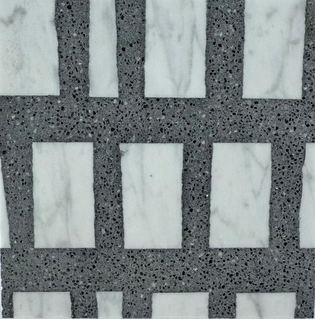 Rectangular white marble tiles are set in a grid with Carlo Scarpa- Dark Gray grout by New York Cement Tile.
