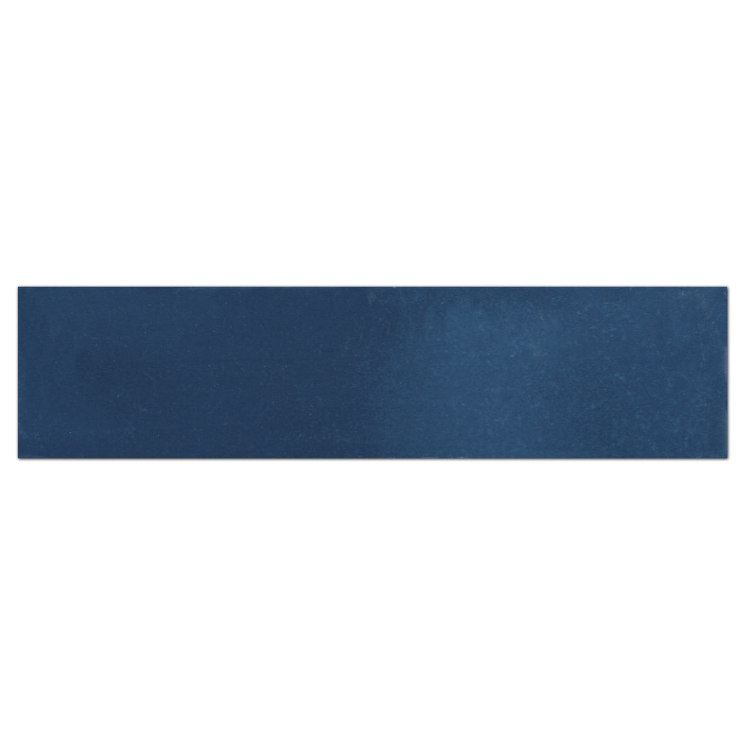 The 2x8 Solid Nautical Depth Sample by New York Cement Tile is a matte dark blue cement subway tile on white background.
