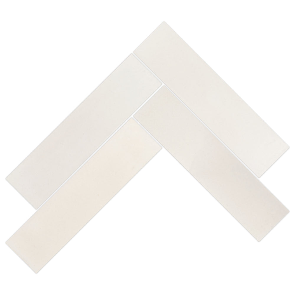 Four 2X8 Beach Beige tiles by New York Cement Tile arranged in a herringbone pattern on a white background.