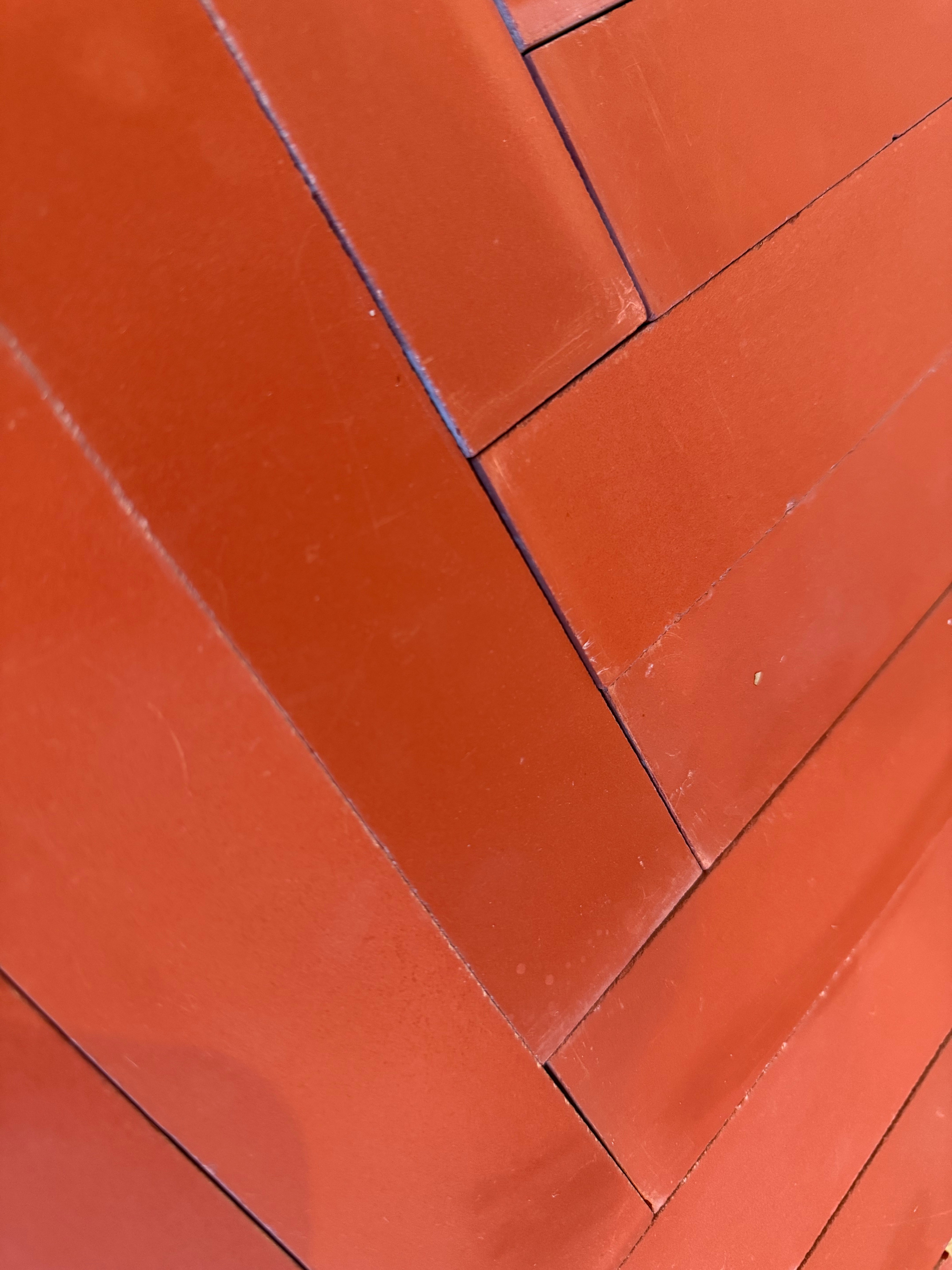 Close-up of diagonally stacked 2X8-Solid Firebrick tiles by New York Cement Tile, showing visible seams and angles.