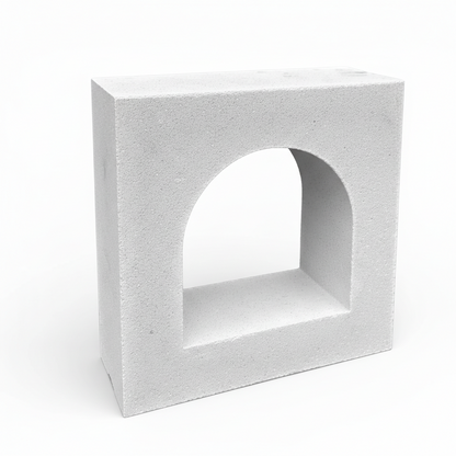 Concrete block with an arch cutout on a white background