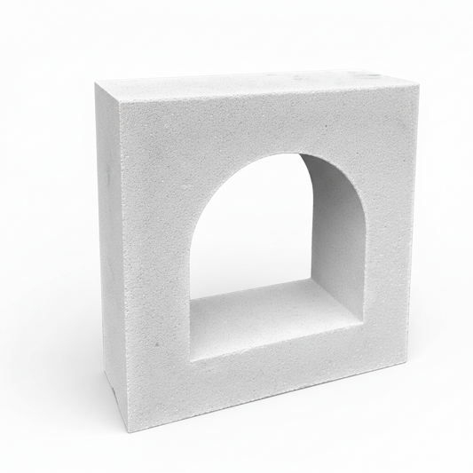 Concrete block with an arch cutout on a white background