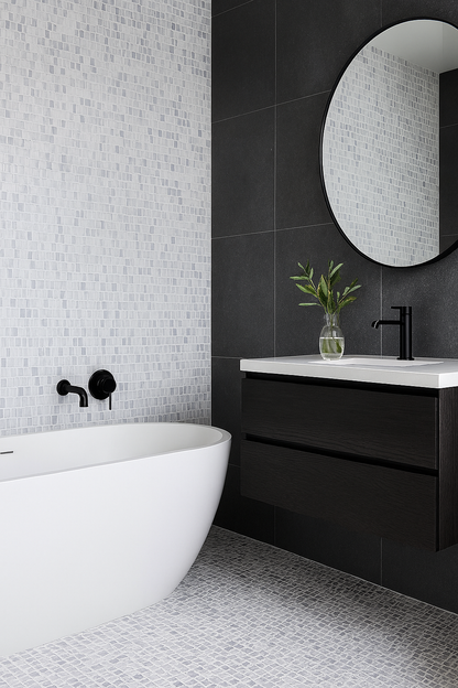Modern bathroom with Carlo Scarpa - Grey Dusk tiles by New York Cement Tile, white tub, black fixtures, and round mirror.