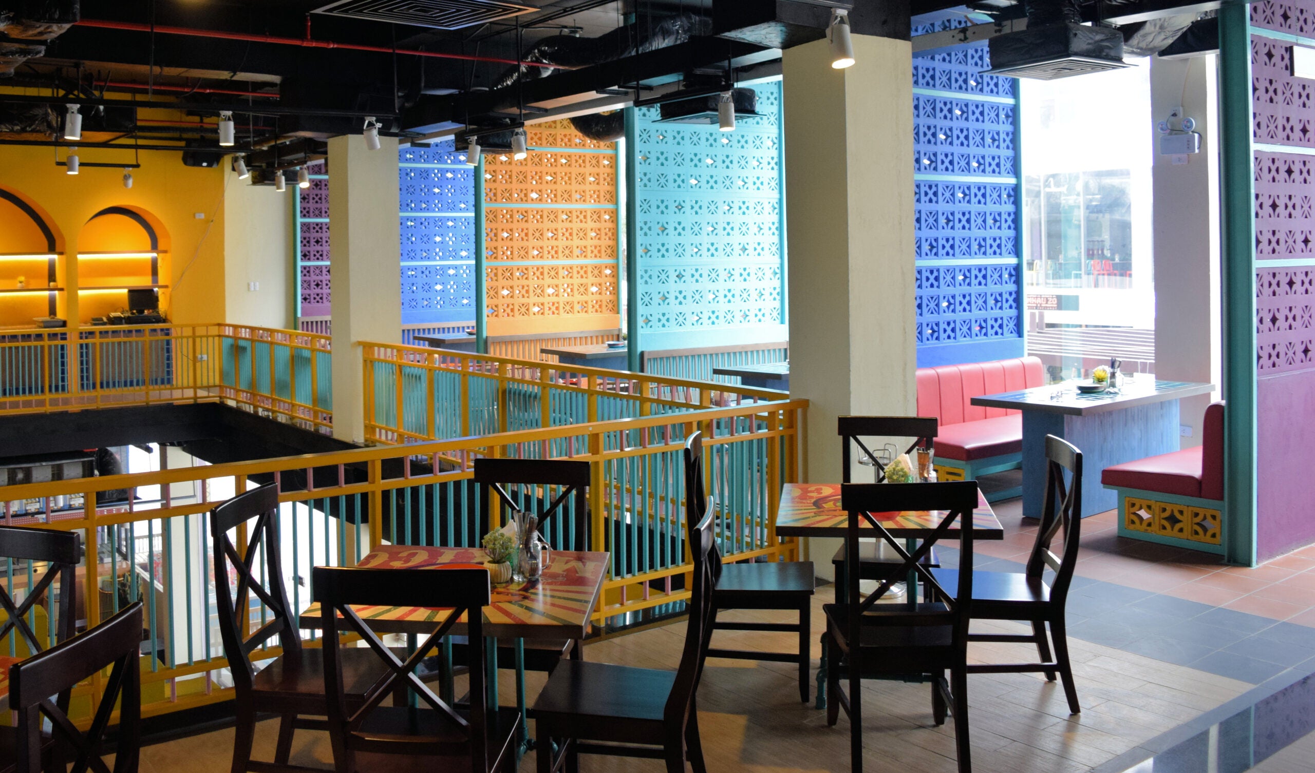 Beeza Sample by New York Cement Tile adds colorful mid-century style and patterned walls to bright, modern cafe interiors.