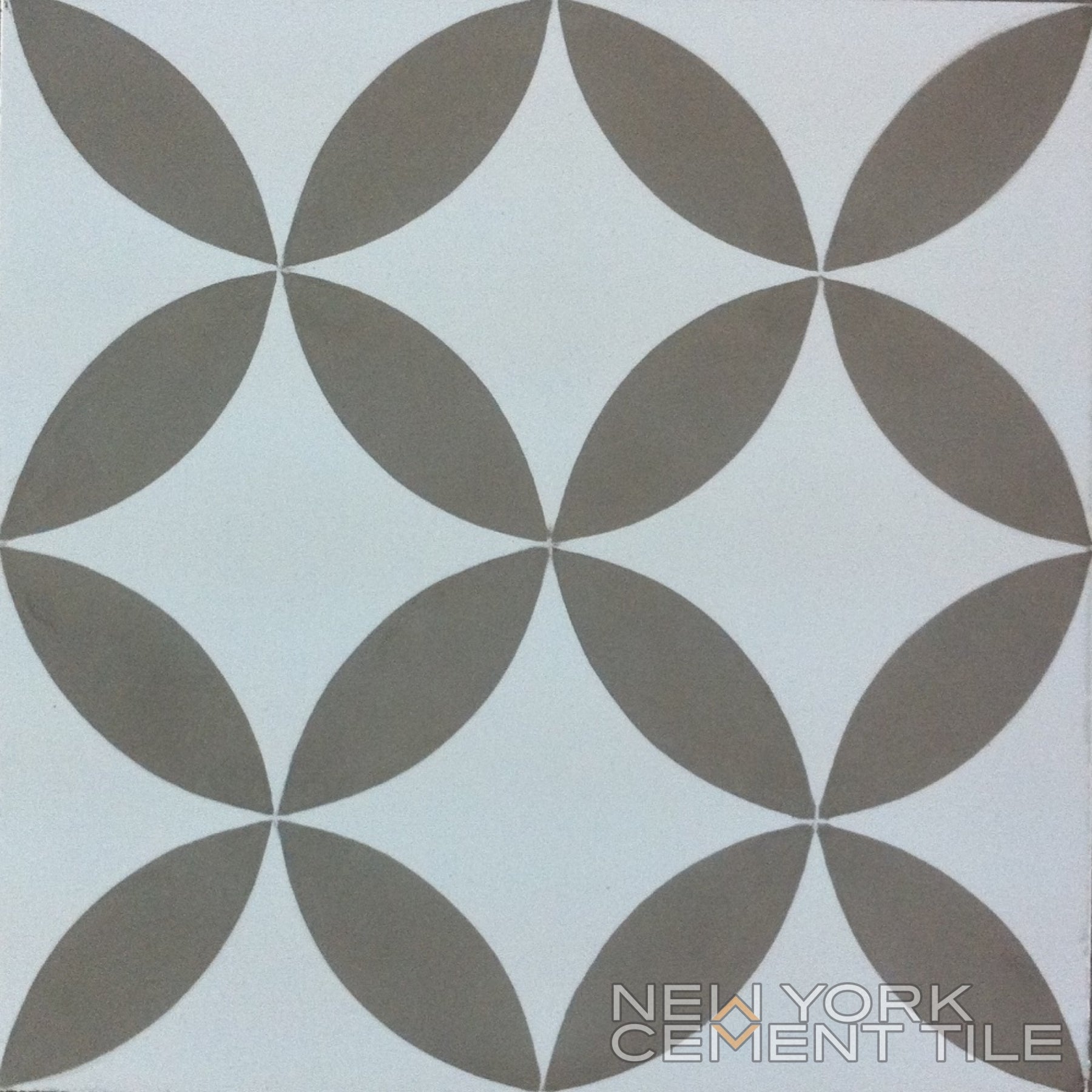 N20-061/062 tile by New York Cement Tile: overlapping brown leaf shapes in a circular pattern on white.