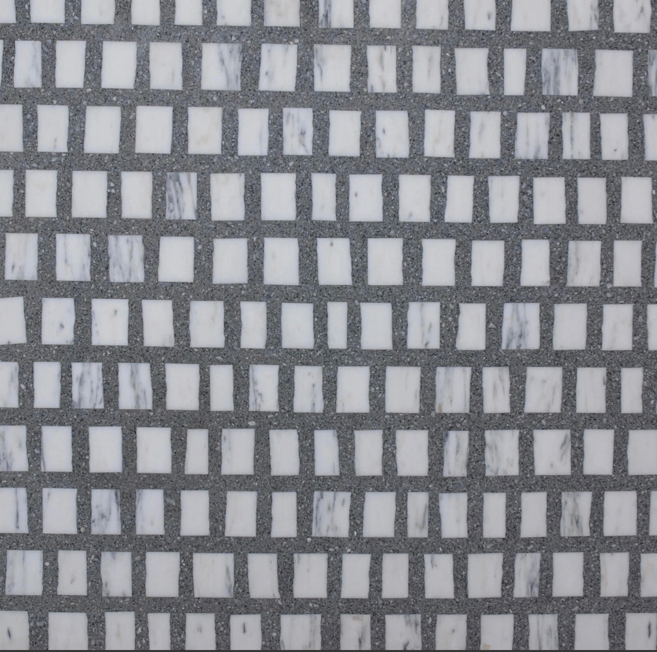 A grid of small, white, square tiles set in gray grout, arranged in a regular, repeating pattern.