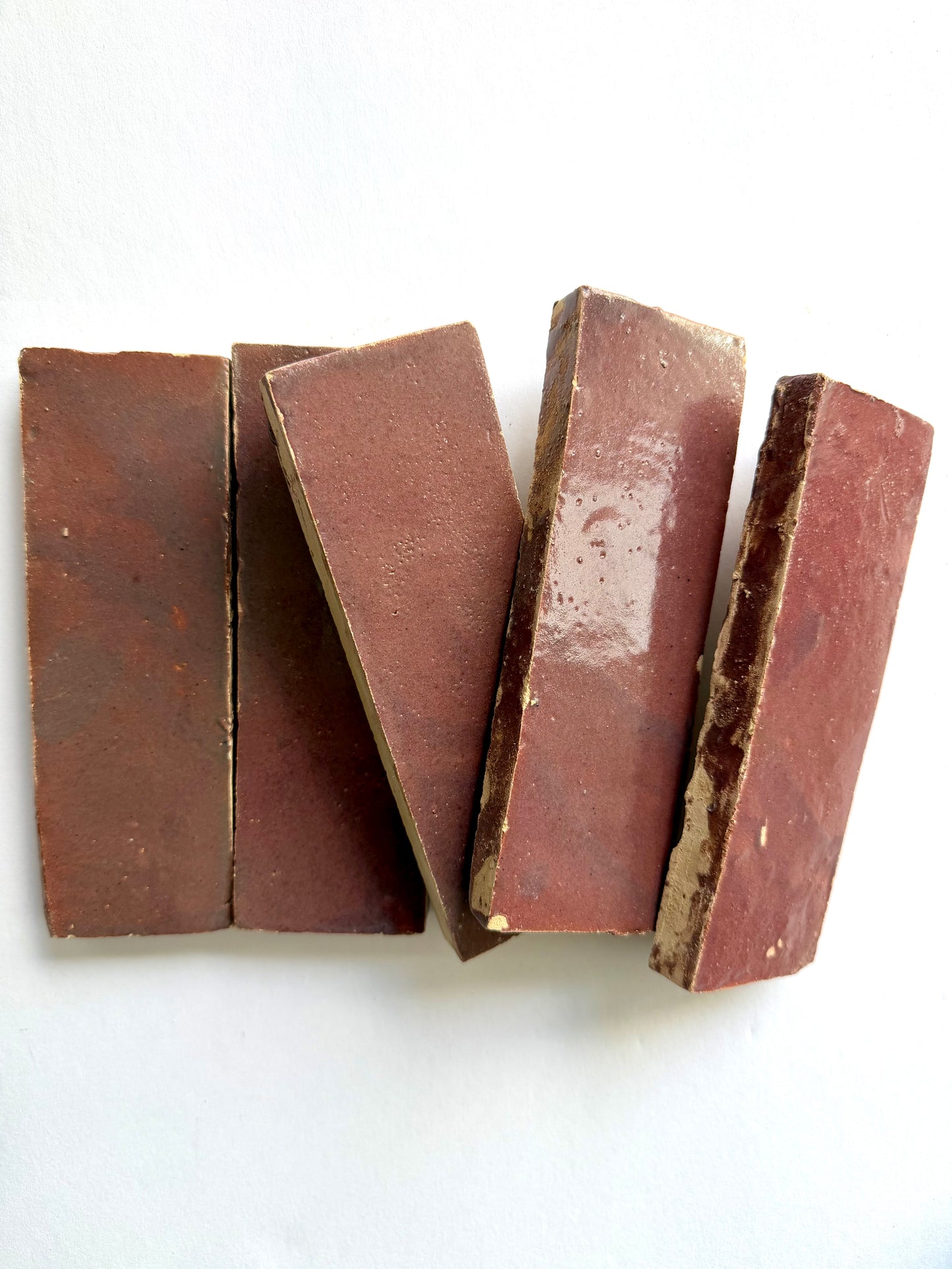 Five Thistle (2x6) tiles by New York Cement Tile are arranged side by side on a white surface.