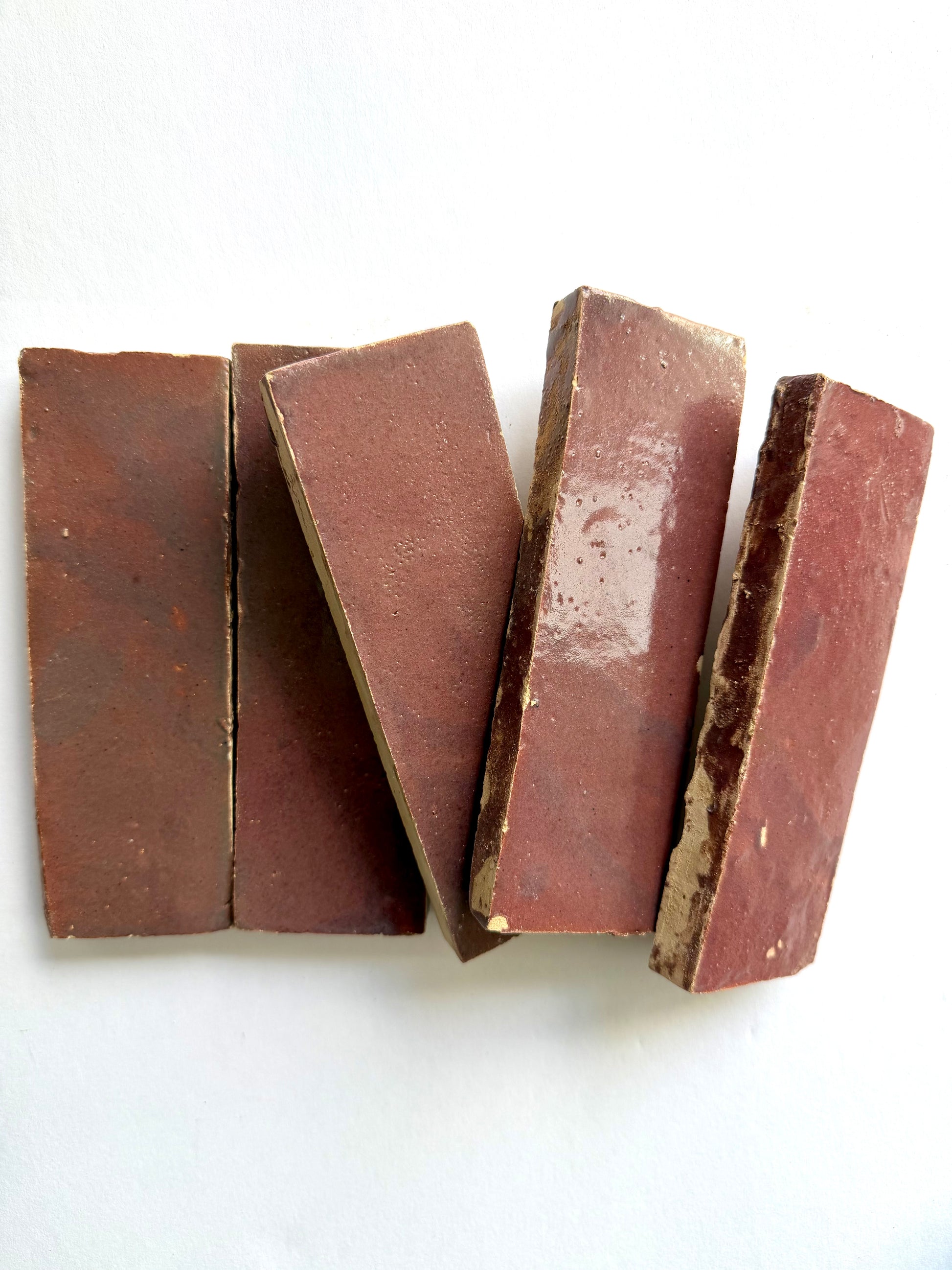 Five Thistle (2x6) tiles by New York Cement Tile are arranged side by side on a white surface.