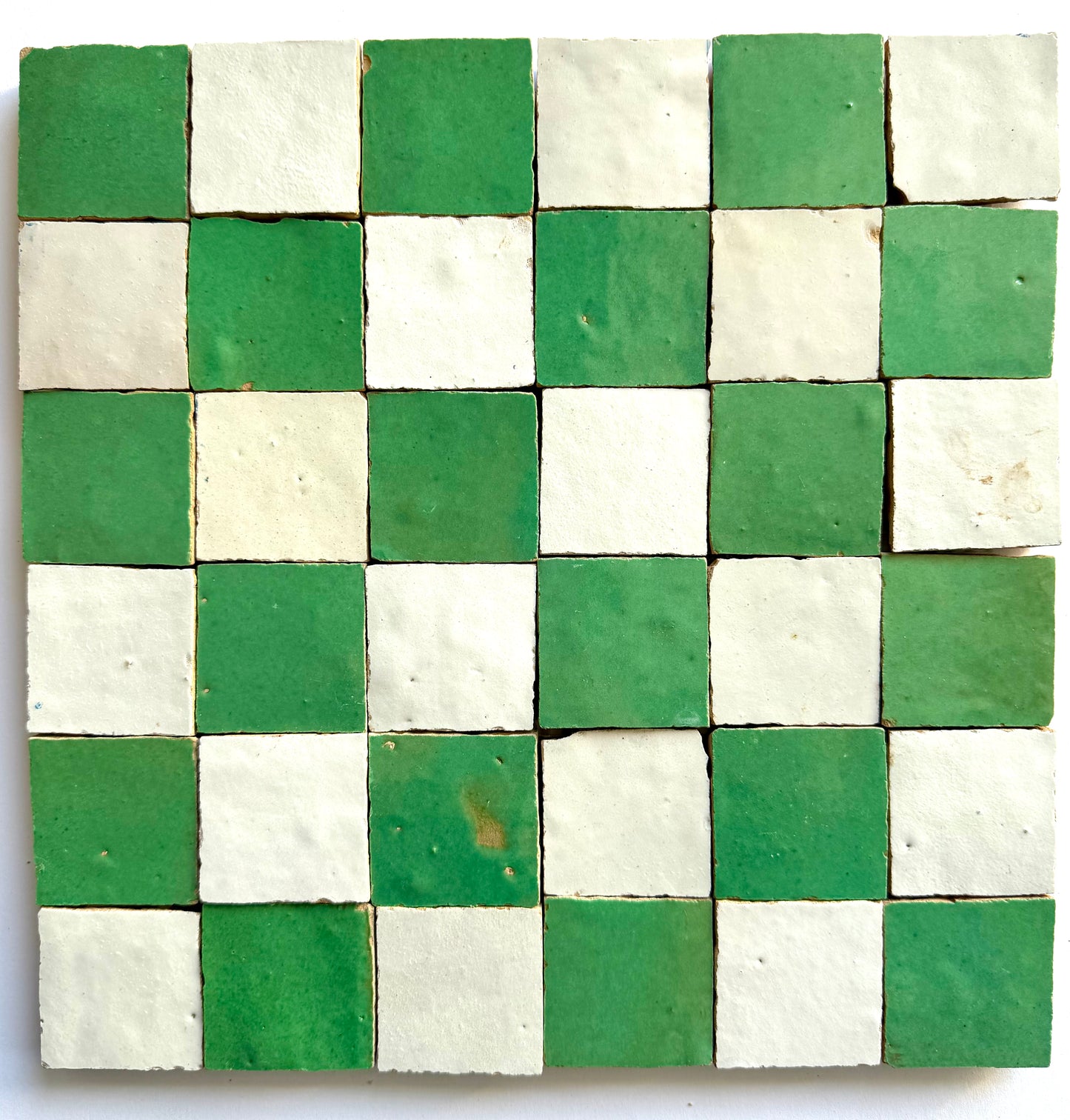 The 2X2 Checkerboard Zellige in Ivory Cloud and Green by New York Cement Tile features small square ceramic tiles.