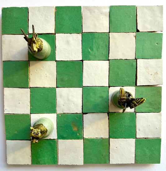 The 2X2 Checkerboard Zellige in Ivory Cloud and Green by New York Cement Tile features animal-themed chess pieces.
