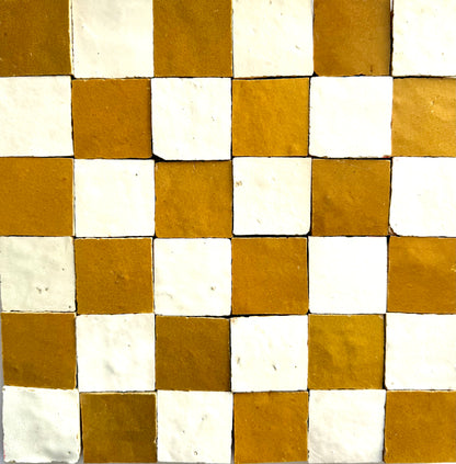 The 2X2 Checkerboard Zellige in Ivory Cloud and Caramel by New York Cement Tile features white and brown square tiles.