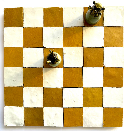 A 2X2 Checkerboard Zellige in Ivory Cloud and Caramel by New York Cement Tile with chess pieces at d4 and h8.