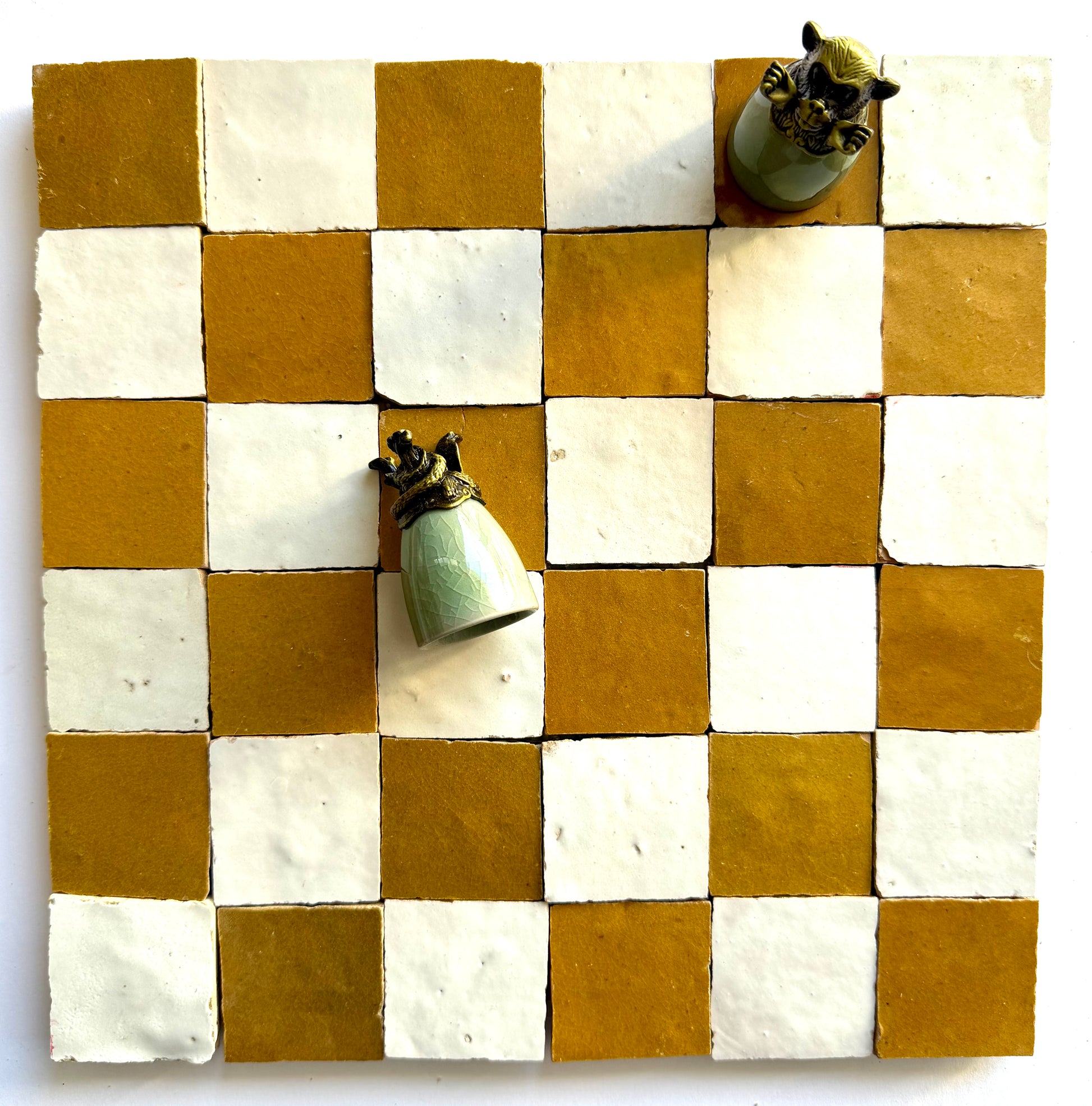 The 2X2 Checkerboard Zellige in Ivory Cloud and Caramel by New York Cement Tile features unique, uneven squares.