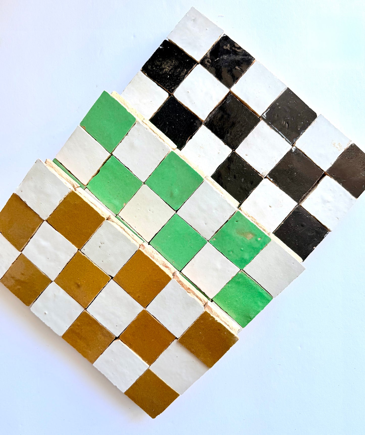 The 2X2 Checkerboard Zellige in Ivory Cloud and Caramel by New York Cement Tile features diagonally arranged colored tiles.