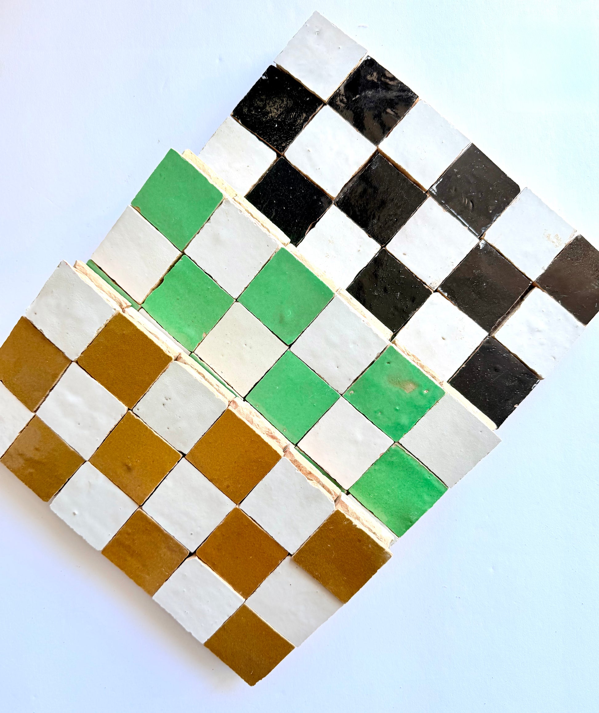 The 2X2 Checkerboard Zellige in Ivory Cloud and Caramel by New York Cement Tile features diagonally arranged colored tiles.