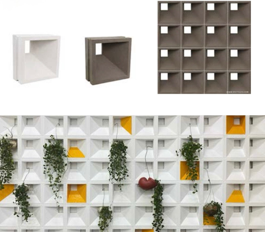 Aku concrete blocks by New York Cement Tile form a geometric privacy screen with plants and a red heart among bold shapes.