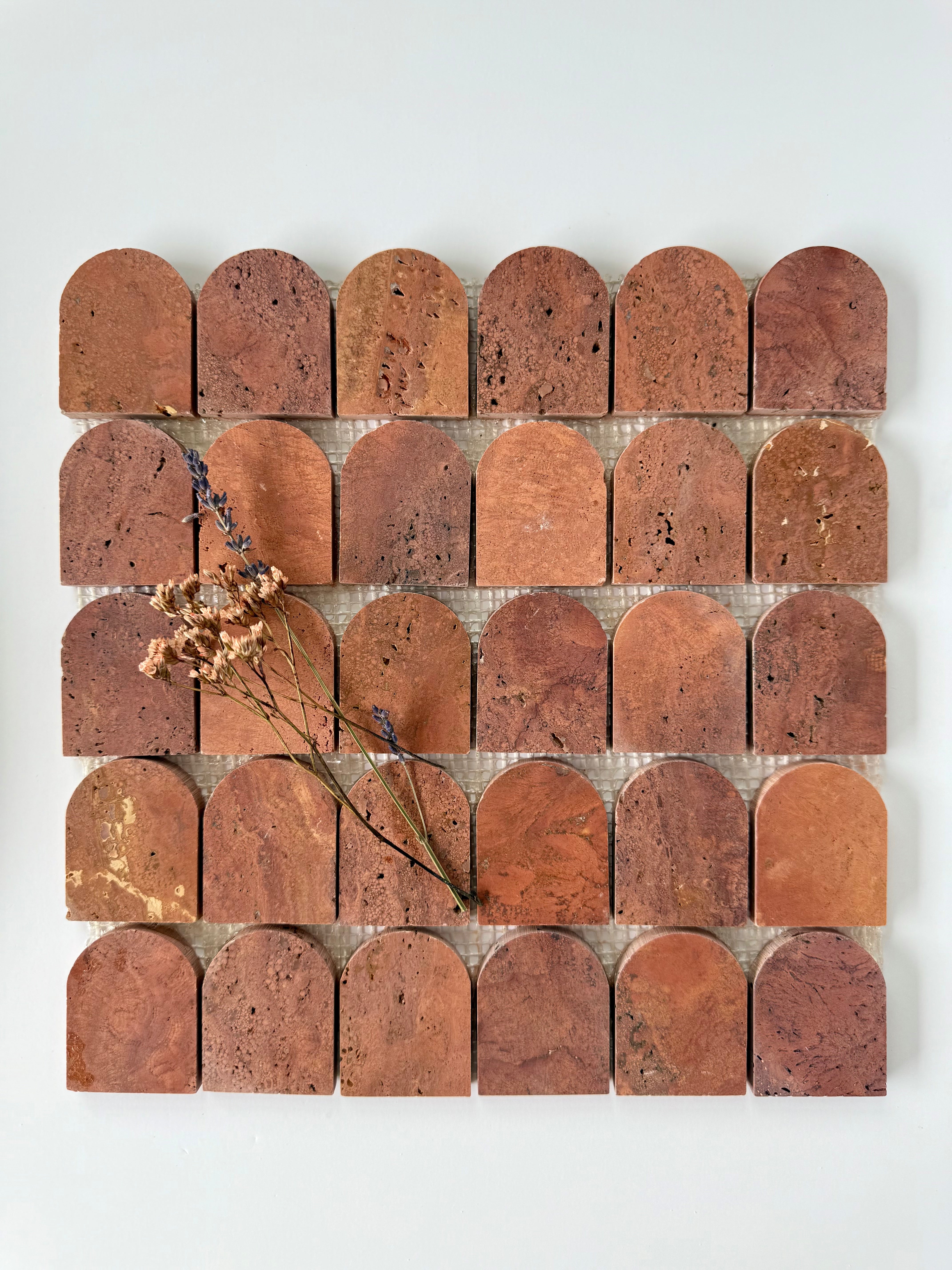 Scarpa I Red Travertine Arch Mosaic by New York Cement Tile features arched tiles in a grid, inspired by the Mesh Collection.
