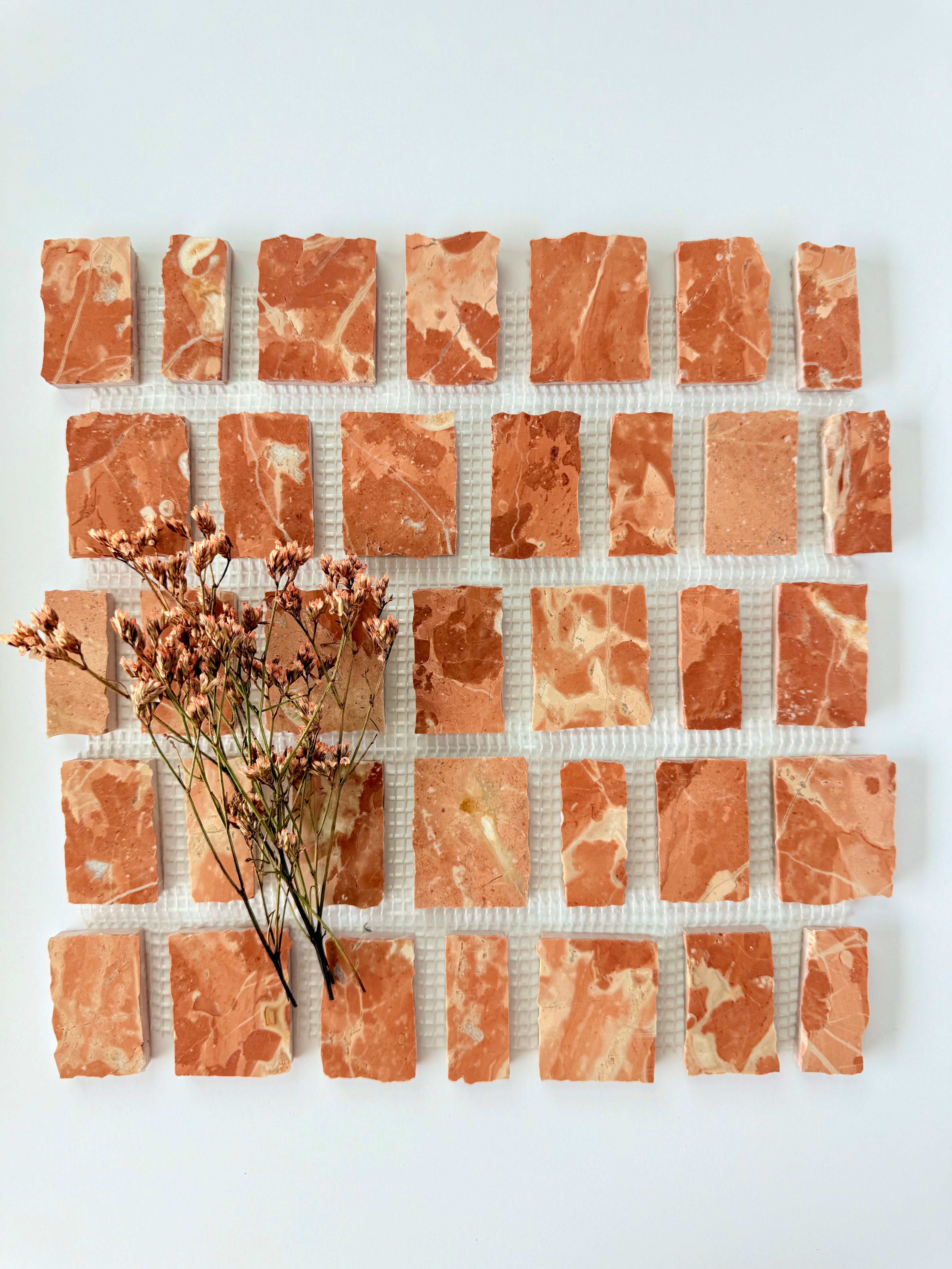 Scarpa I Earth Mosaic Marble Mesh sample by New York Cement Tile, inspired by Italian design, on a white background.